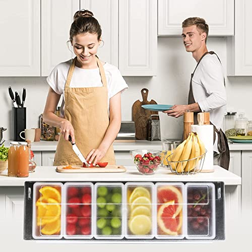Couple cooking in modern white kitchen with six-compartment fruit garnish organizer on counter filled with colorful citrus and berries