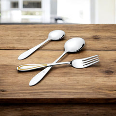 Cutlery trio placed on rustic wooden surface, featuring one piece with gold inlay on handle.
