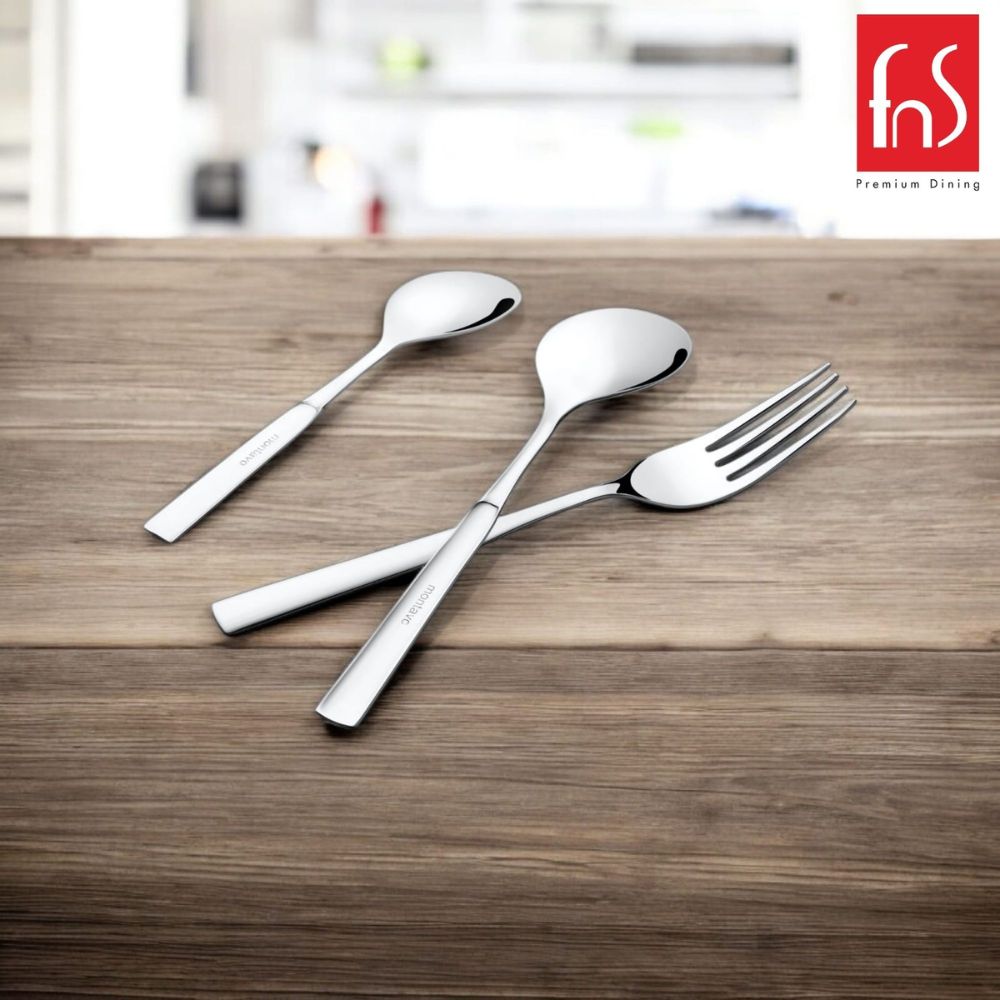 Three polished cutlery pieces arranged on wooden table with blurred kitchen background and brand logo.