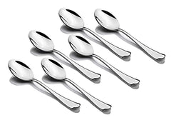 Six polished stainless steel tablespoons arranged diagonally with matching contoured handles on white surface.