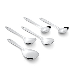 Montavo Amazon 5-piece serving spoons scattered on white background including rice server, vegetable spoons, and gravy ladles with ergonomic oval handles.
