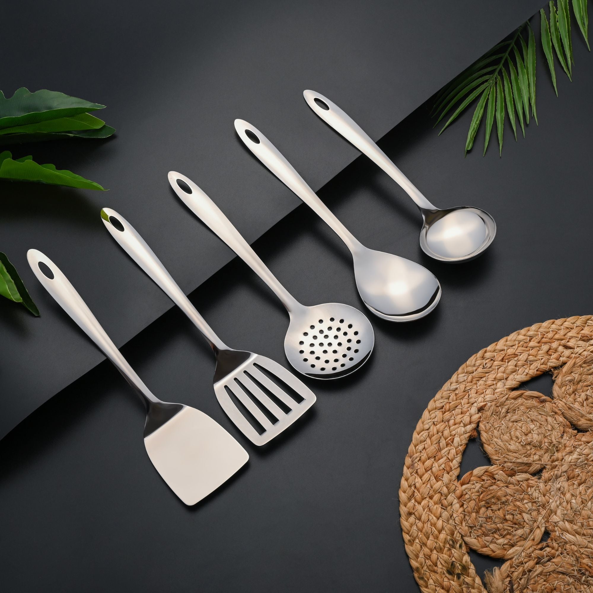 Montavo Amazon stainless steel serving spoons set displaying all five utensils on lifestyle background.