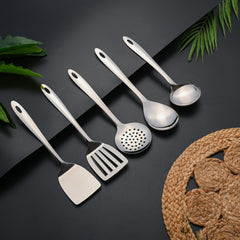 Montavo Amazon stainless steel serving spoons set displaying all five utensils on lifestyle background.