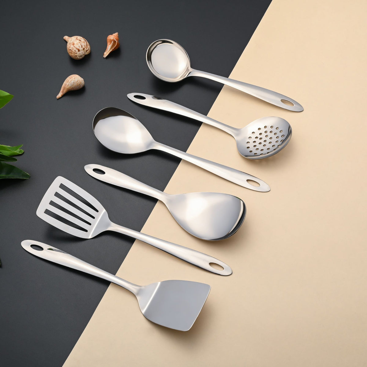 Montavo Amazon serving tools 6-piece set flatlay showing complete kitchen utensils on dual-tone black and beige background with shells