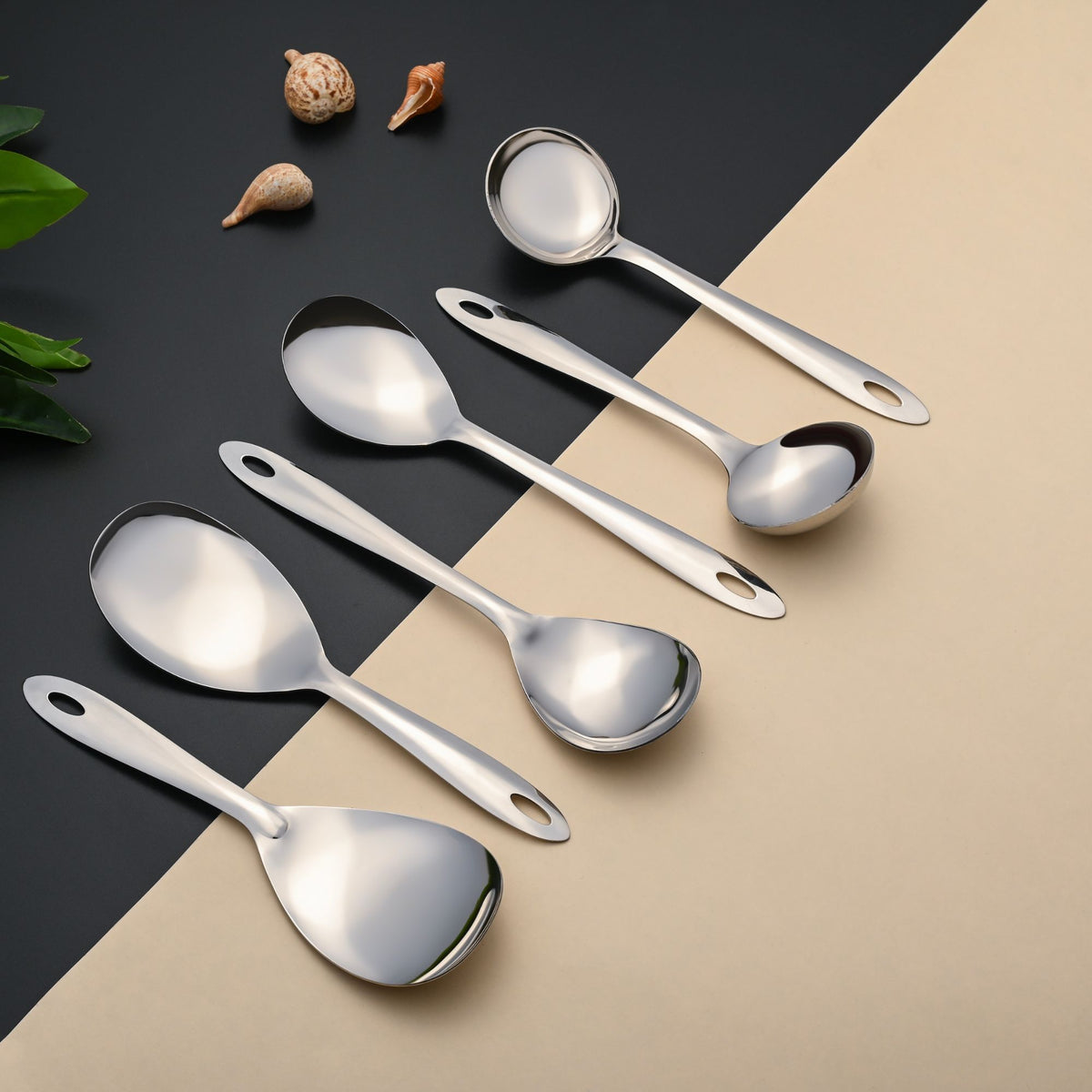 Montavo Amazon serving utensils set of 6 displayed diagonally on dual-tone background with decorative shells