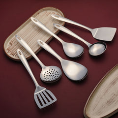 Montavo Amazon stainless steel 6-piece serving utensil set arranged on wooden tray with burgundy table setting and plates