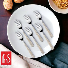 Six stainless steel forks with textured beige handles arranged on white plate