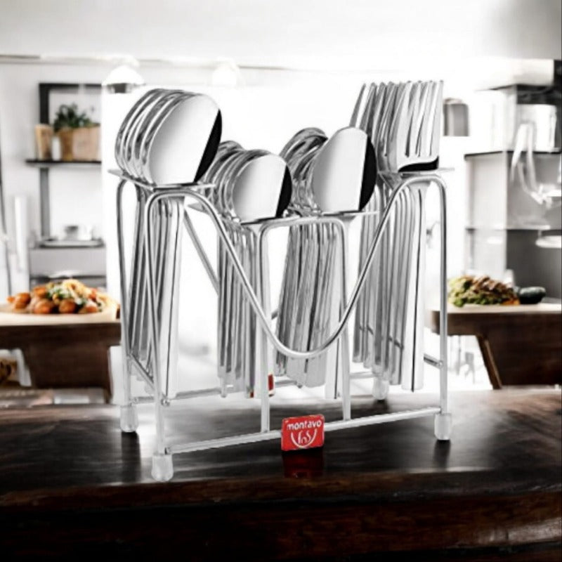 Stainless steel cutlery set in a modern rack displayed on a kitchen counter with food background.