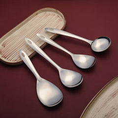 Premium Montavo stainless steel serving spoons set arranged elegantly with wooden coaster on burgundy textured background.