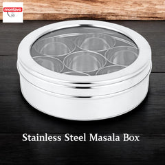 Montavo by fns stainless steel masala box with 7 inner containers and transparent see-through lid, placed on dark wooden surface