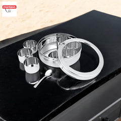 Montavo by fns stainless steel masala box fully disassembled showing individual spice containers, outer ring, lid and spoon arranged on a black granite countertop