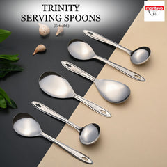 Montavo by FNS Trinity 6-piece stainless steel serving spoon set displayed diagonally on dual-tone surface with decorative shells and leaves