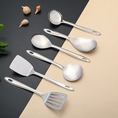 Montavo Trinity serving tools displayed diagonally on modern background with shells and natural elements, highlighting premium stainless steel quality and design.