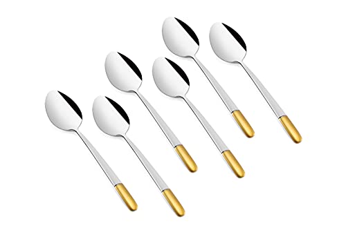 Six polished stainless steel spoons with shiny gold handles arranged neatly against a white background.