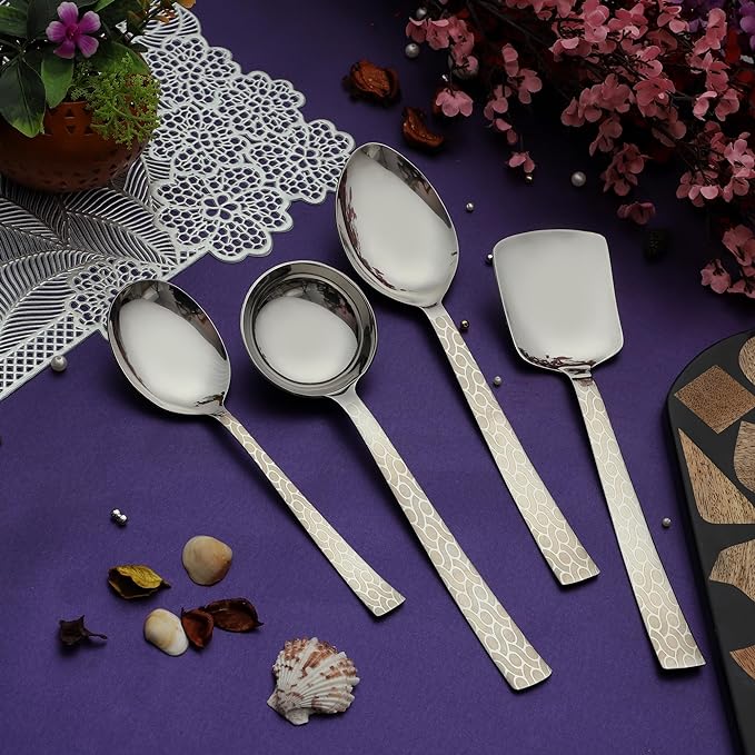 Pacific serving set arranged on purple fabric with decorative flowers, shells, and lace doily for elegant table display