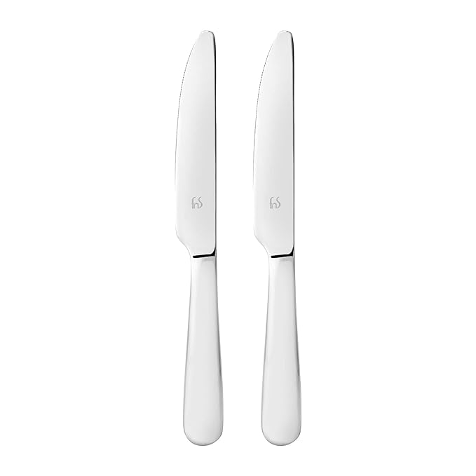 Pair of stainless steel butter knives with smooth rounded handles and mirror finish standing upright on clean white background for product photography.