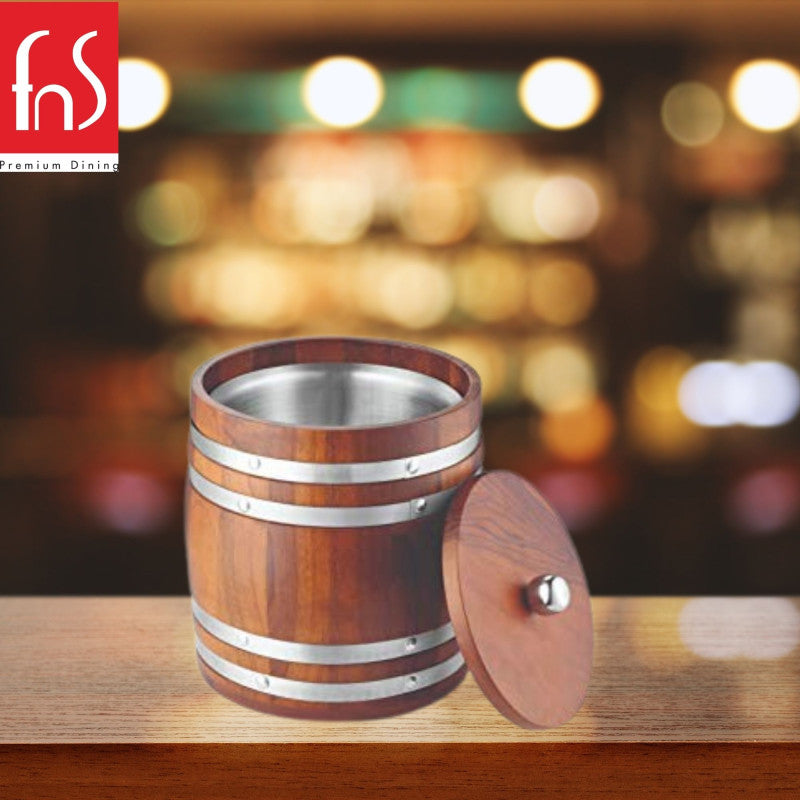 Premium wooden barrel ice bucket with stainless steel bands on bar counter with warm bokeh lighting and blurred restaurant background