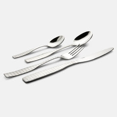 Four stainless steel cutlery pieces with geometric-textured handles laid diagonally on plain white background.