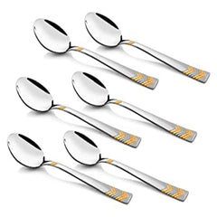 Six Raga stainless steel dinner spoons featuring mirror polished bowls and elegant 24K gold plated geometric chevron design handles arranged on white