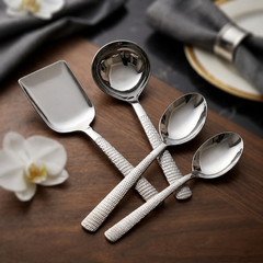 FnS Madrid 4-Pc stainless steel serving set with hammered handles, including ladle and serving spoons on wooden table.