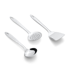 Stainless steel Amazon serving set with gravy ladle, perforated skimmer, and flat spatula on white background diagonal view