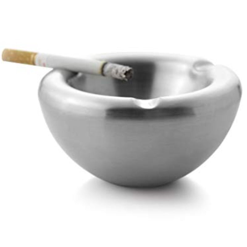 Stainless steel ashtray with lit cigarette resting on edge, close-up shot on white background