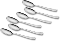 Top view of six silver spoons with circular embossed handles arranged in two neat horizontal rows.