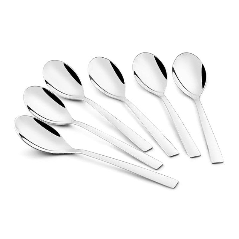 Six stainless steel dessert spoons with mirror finish arranged in elegant fan pattern on white background