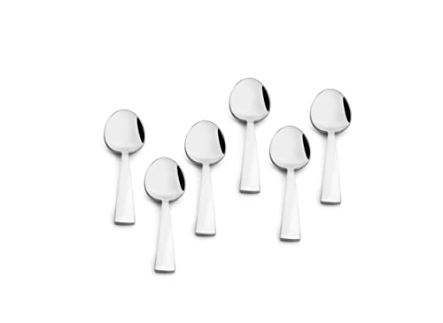 Six compact baby spoons with wide heads and short, flat handles arranged evenly on a plain surface.