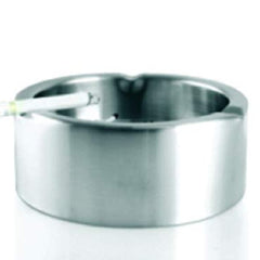 Round stainless steel ashtray with cigarette rest grooves, empty side view on white background