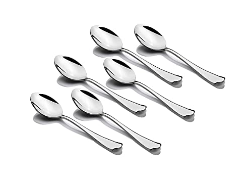 Set of six shiny stainless dessert spoons laid out neatly on plain white background.