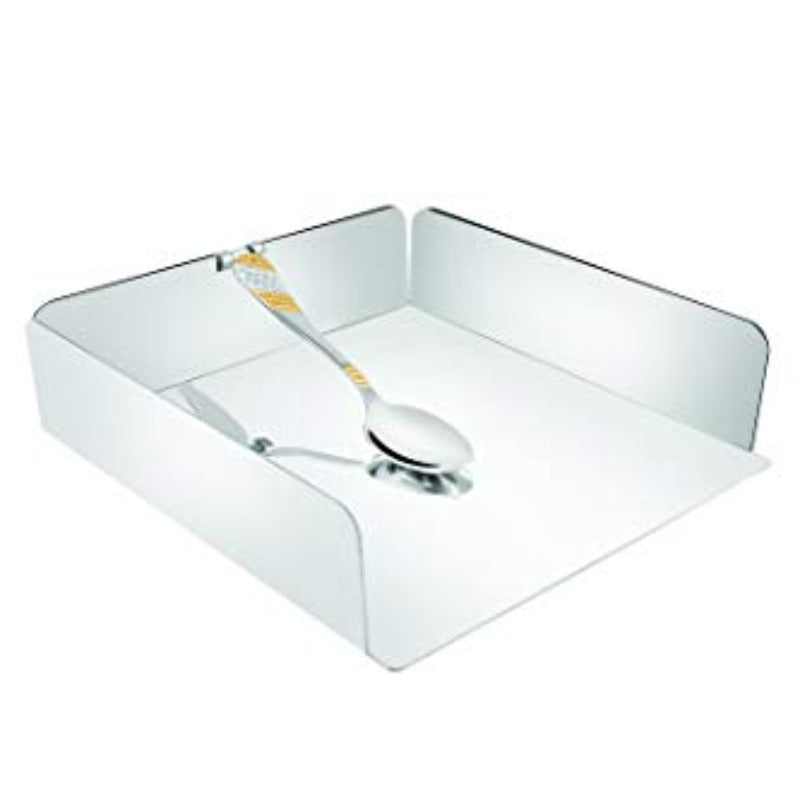 Stainless steel square open-top napkin holder with a decorative gold-accented spoon resting inside, on white background