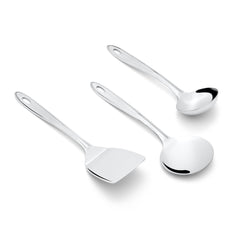Three-piece Trinity serving utensil set with spatula, serving spoon, and ladle on white background top view