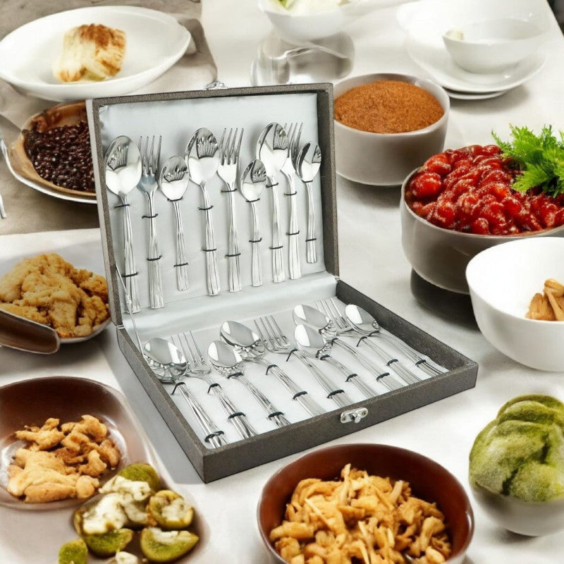 Cutlery gift box opened on dining table surrounded by bowls of snacks and Indian cuisine.