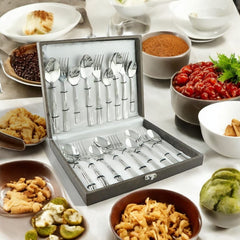 Cutlery gift box opened on dining table surrounded by bowls of snacks and Indian cuisine.