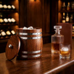 FnS wooden finish stainless steel ice bucket with lid and ice cubes, displayed on a bar counter with blurred glassware.